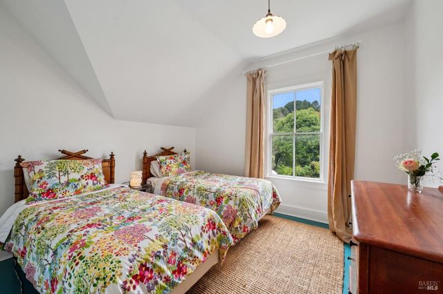 a view of a backyard with table and chairs potted plants and wooden fence