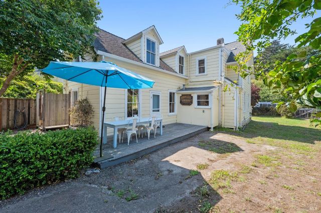 a view of backyard with outdoor seating and plants