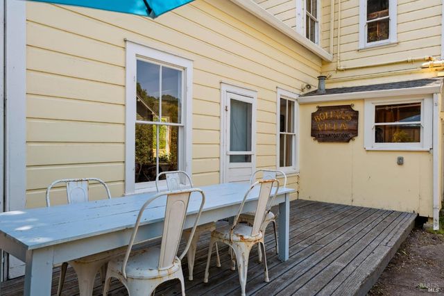 a view of backyard with outdoor seating and plants