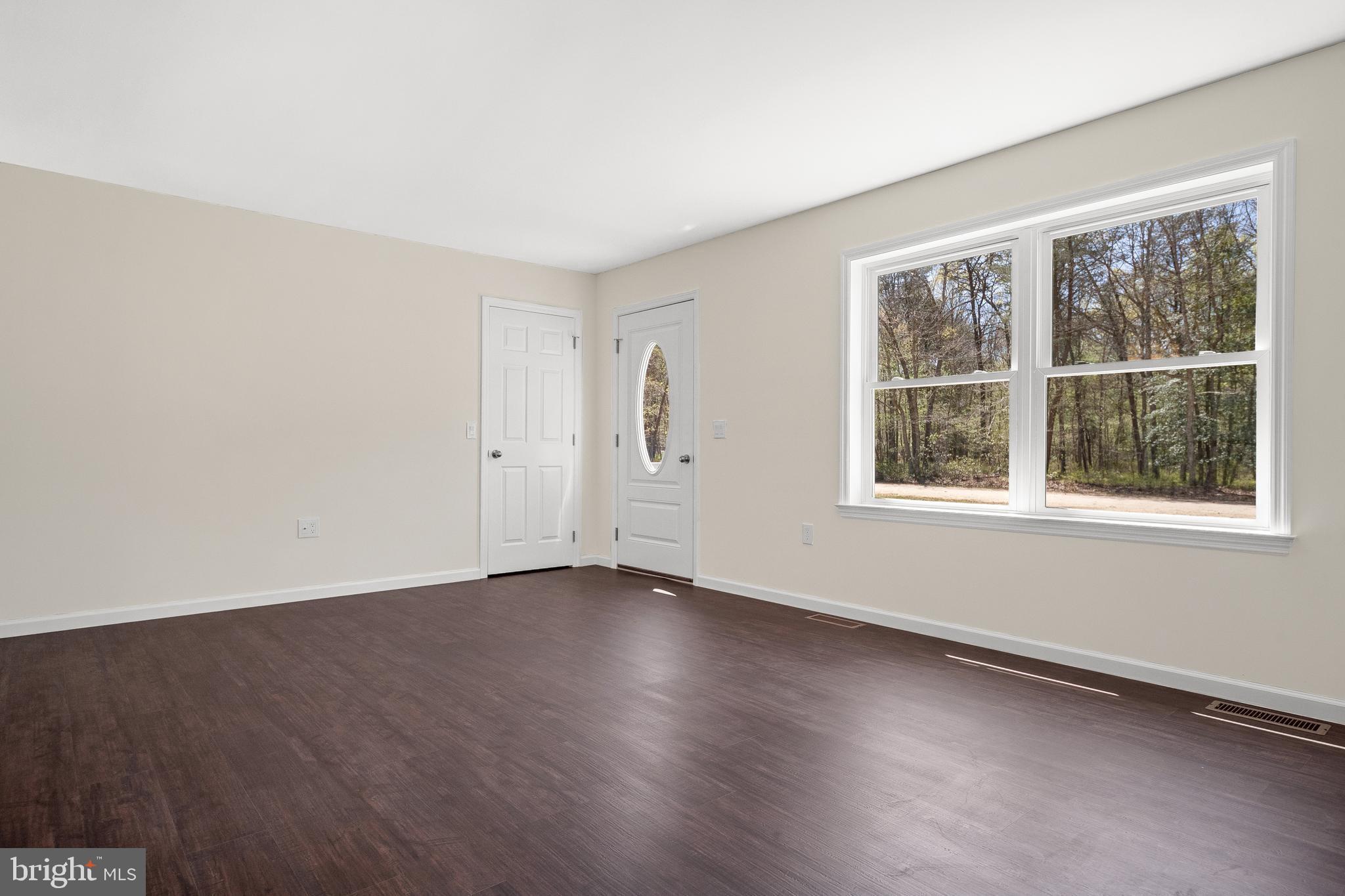 666 Irving Avenue Bridgeton, NJ 08302 - Photo 17 of 41 an empty room with wooden floor and windows