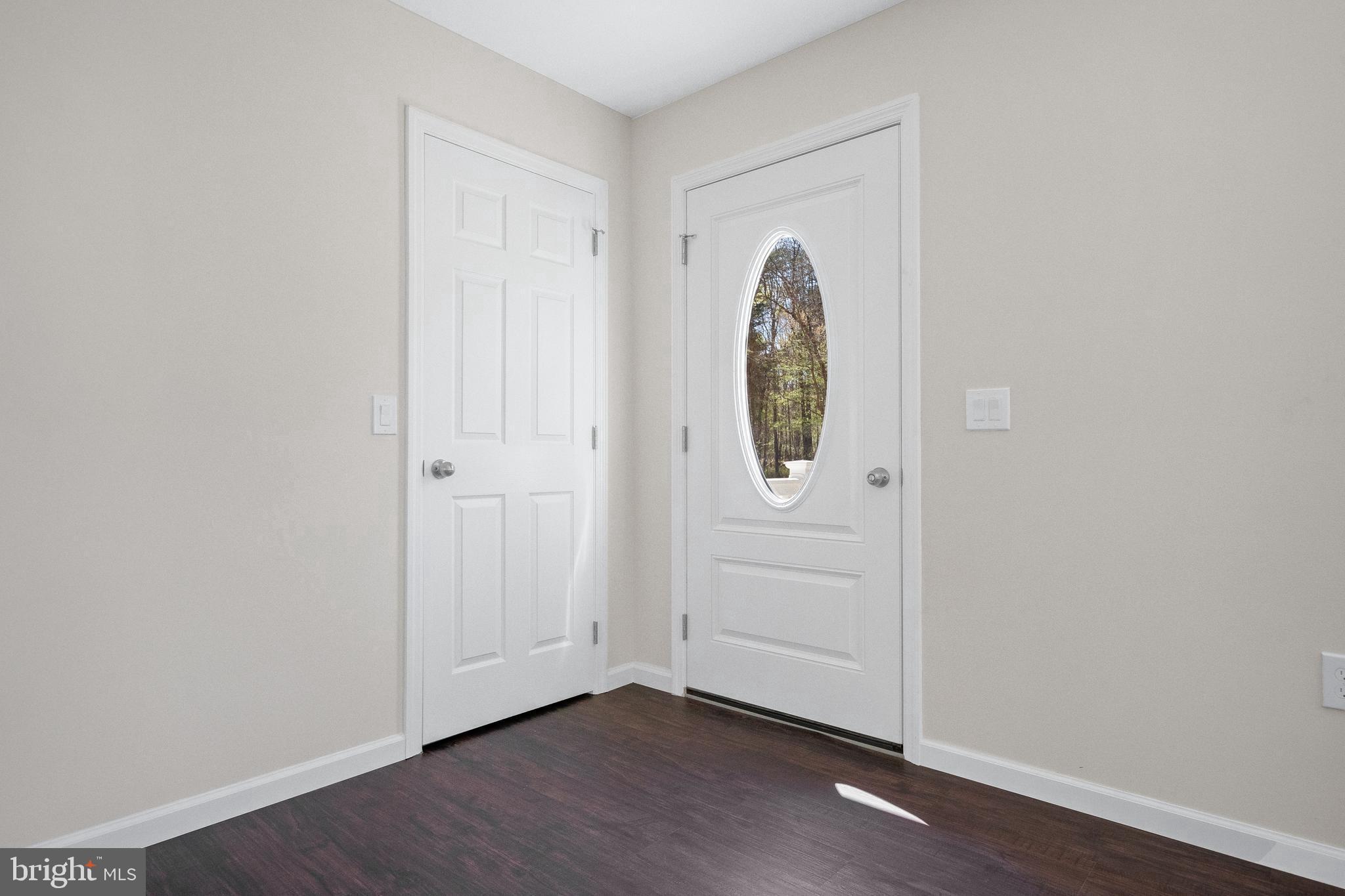 666 Irving Avenue Bridgeton, NJ 08302 - Photo 18 of 41 an empty room with wooden floor and mirror