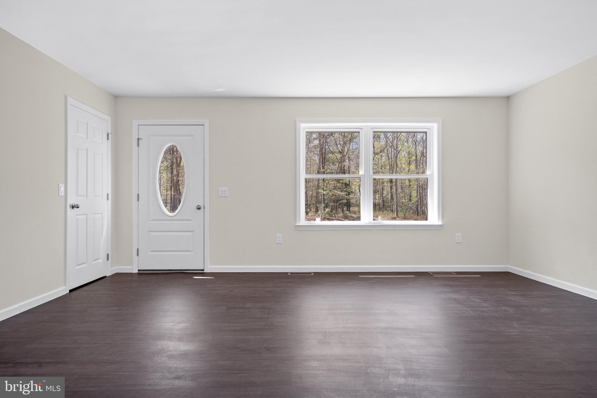 666 Irving Avenue Bridgeton, NJ 08302 - Photo 19 of 41 an empty room with wooden floor and windows