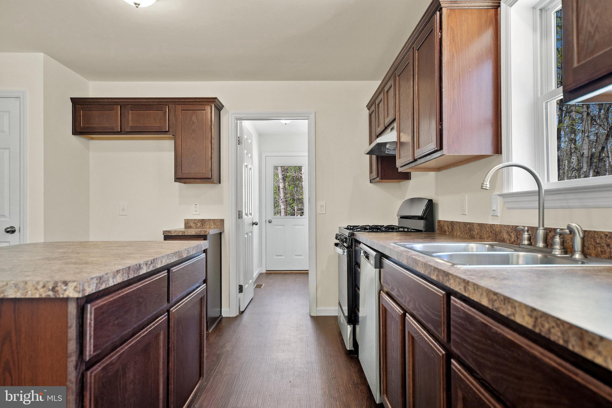 666 Irving Avenue Bridgeton, NJ 08302 - Photo 6 of 41 a kitchen with stainless steel appliances granite countertop a sink stove and cabinets