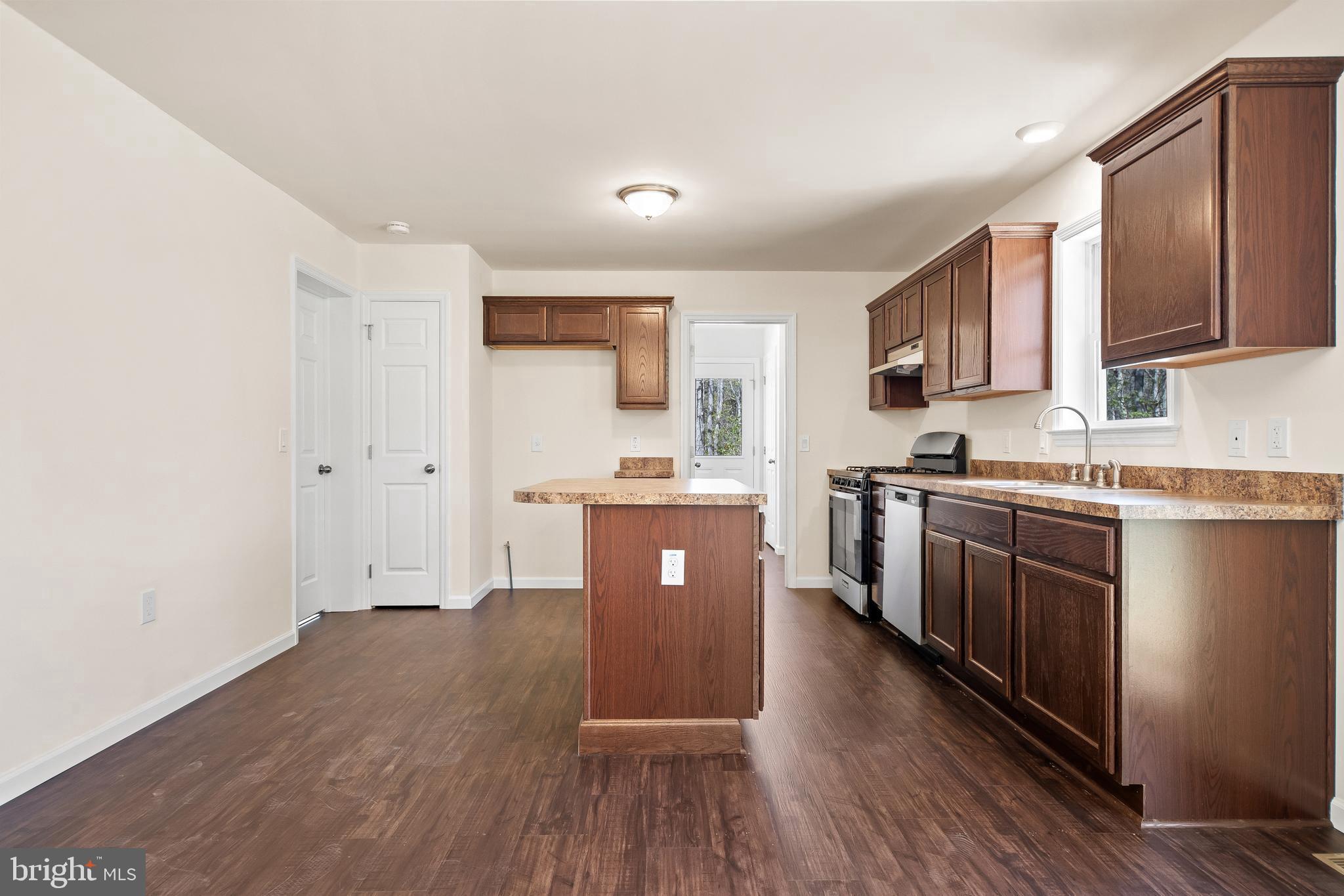 666 Irving Avenue Bridgeton, NJ 08302 - Photo 8 of 41 a large kitchen with stainless steel appliances granite countertop a stove a sink dishwasher and a refrigerator with wooden floor