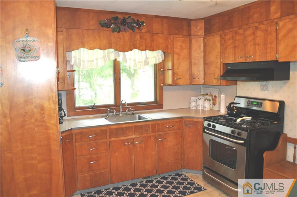 547 Ridge Road Monmouth Junction, NJ 08852 - Photo 11 of 25 a kitchen with a sink a stove and a window