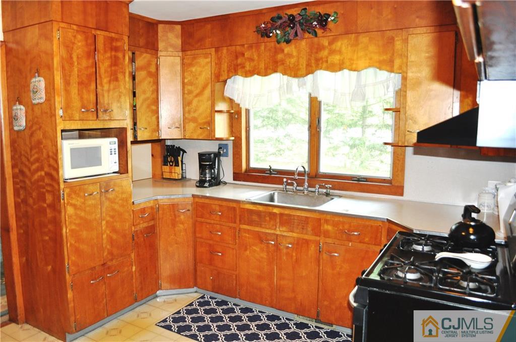 547 Ridge Road Monmouth Junction, NJ 08852 - Photo 12 of 25 a kitchen with sink a window and cabinets