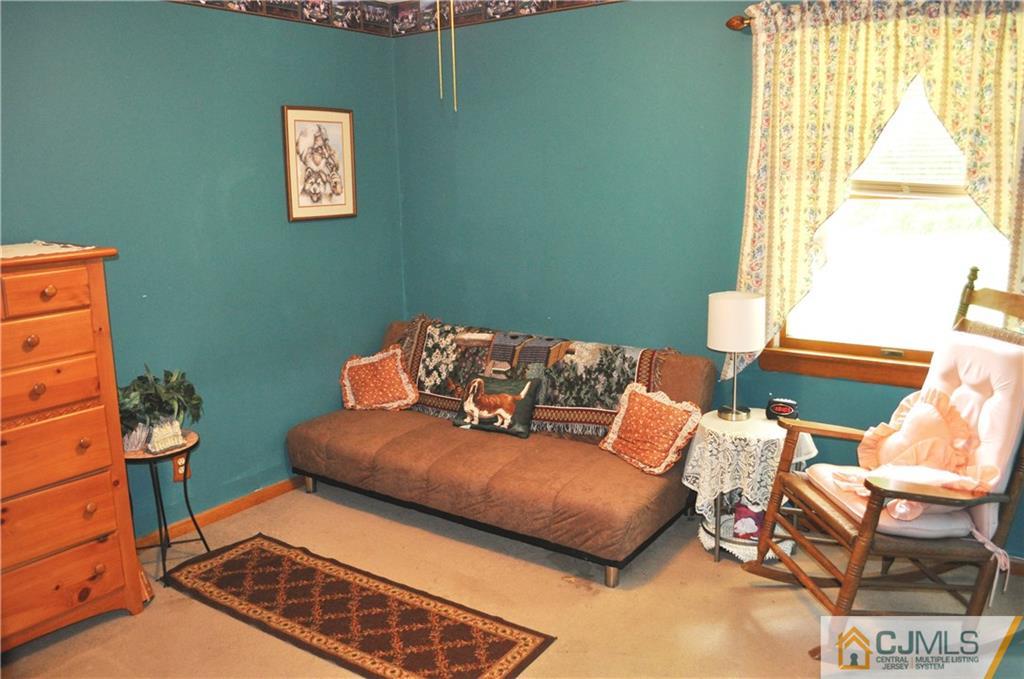 547 Ridge Road Monmouth Junction, NJ 08852 - Photo 16 of 25 a blue and white sitting area with a window