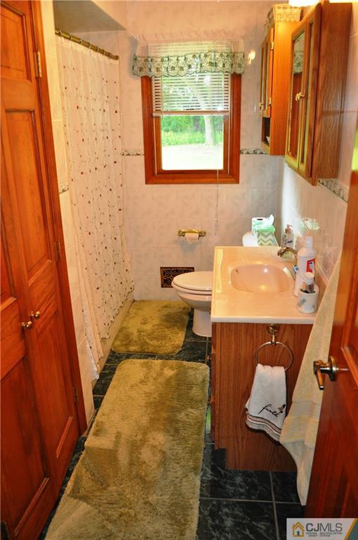 547 Ridge Road Monmouth Junction, NJ 08852 - Photo 18 of 25 a bathroom with a sink and a mirror