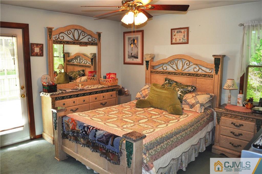 547 Ridge Road Monmouth Junction, NJ 08852 - Photo 20 of 25 a bedroom with a bed a dresser next to a window