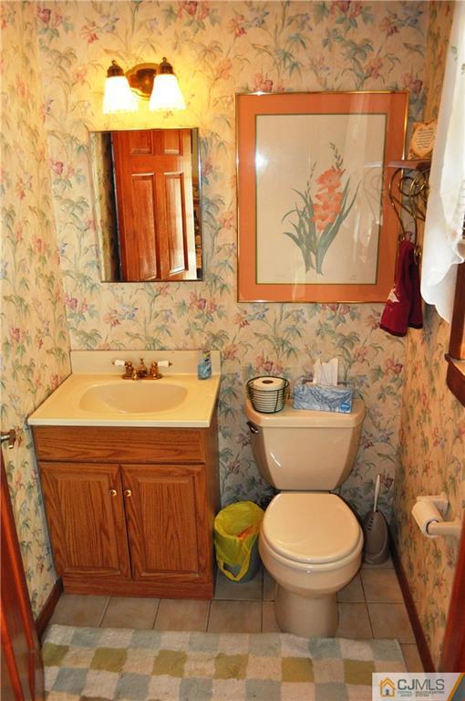 547 Ridge Road Monmouth Junction, NJ 08852 - Photo 22 of 25 a bathroom with a toilet a sink and mirror