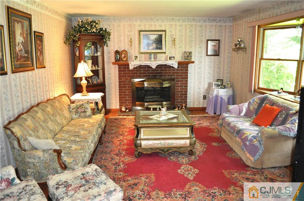 547 Ridge Road Monmouth Junction, NJ 08852 - Photo 6 of 25 a living room with furniture and a fireplace