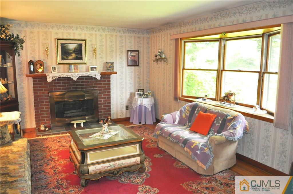547 Ridge Road Monmouth Junction, NJ 08852 - Photo 7 of 25 a living room with furniture fireplace and window