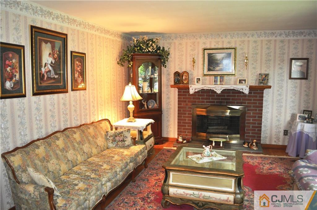 547 Ridge Road Monmouth Junction, NJ 08852 - Photo 8 of 25 a living room with furniture and a fireplace