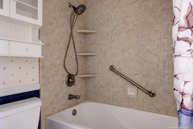 a bathroom with a bath tub and a shower