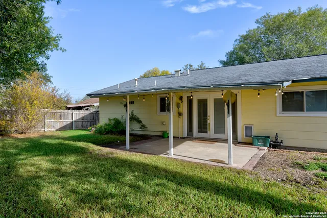 a view of a house with backyard porch and sitting area
