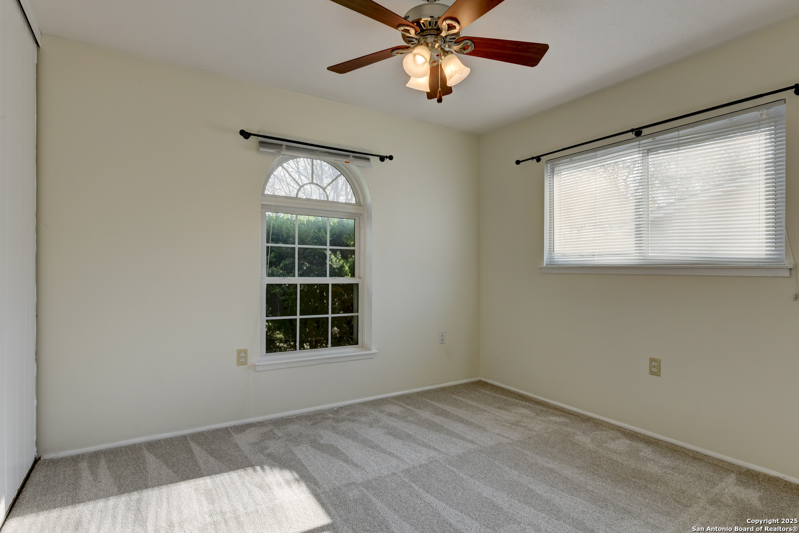 12401 Trailing Oaks Street Live Oak, TX 78233 - Photo 21 of 31 an empty room with a window and ceiling fan