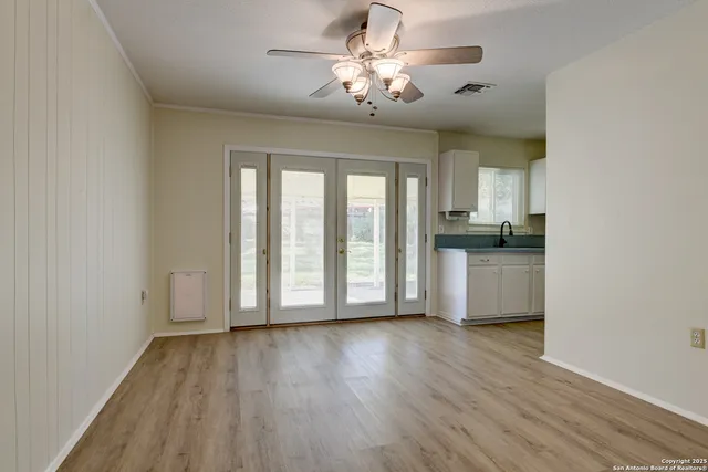 a view of a kitchen with wooden floor and a window