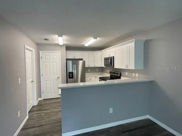 a kitchen with a stove a refrigerator and a sink