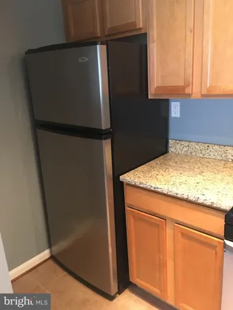 a kitchen with a refrigerator and cabinets