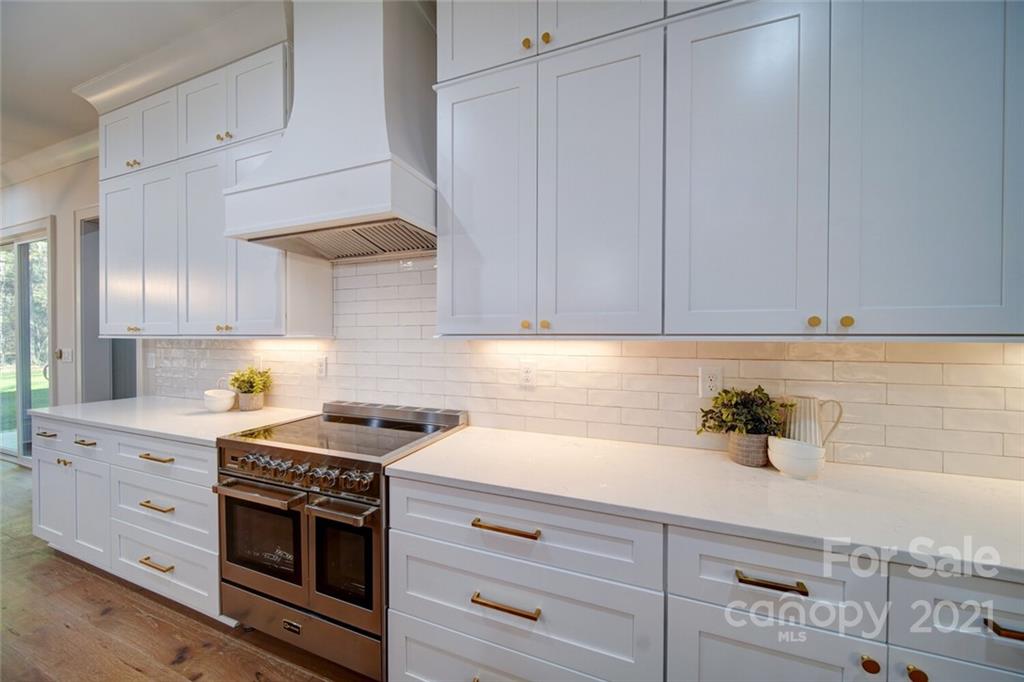 3017 McLendon Road Matthews, NC 28104 - Photo 16 of 47 a kitchen with stainless steel appliances granite countertop a sink a stove and cabinets