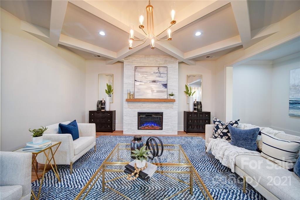 3017 McLendon Road Matthews, NC 28104 - Photo 20 of 47 a living room with furniture a fireplace and a chandelier