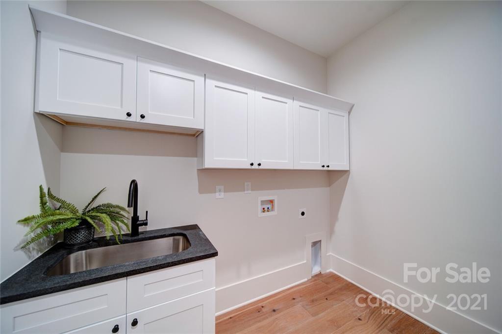 3017 McLendon Road Matthews, NC 28104 - Photo 26 of 47 a view of kitchen with white cabinets and wooden floor
