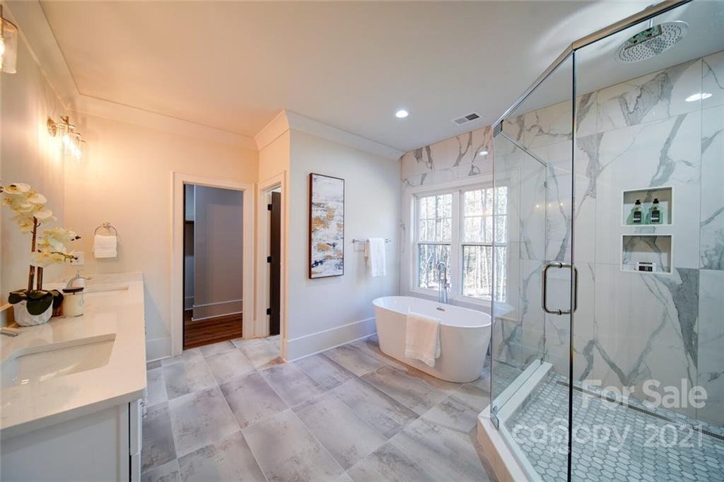 3017 McLendon Road Matthews, NC 28104 - Photo 34 of 47 a spacious bedroom with a bed and glass door