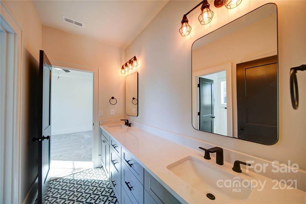 3017 McLendon Road Matthews, NC 28104 - Photo 45 of 47 a bathroom with a sink and a mirror