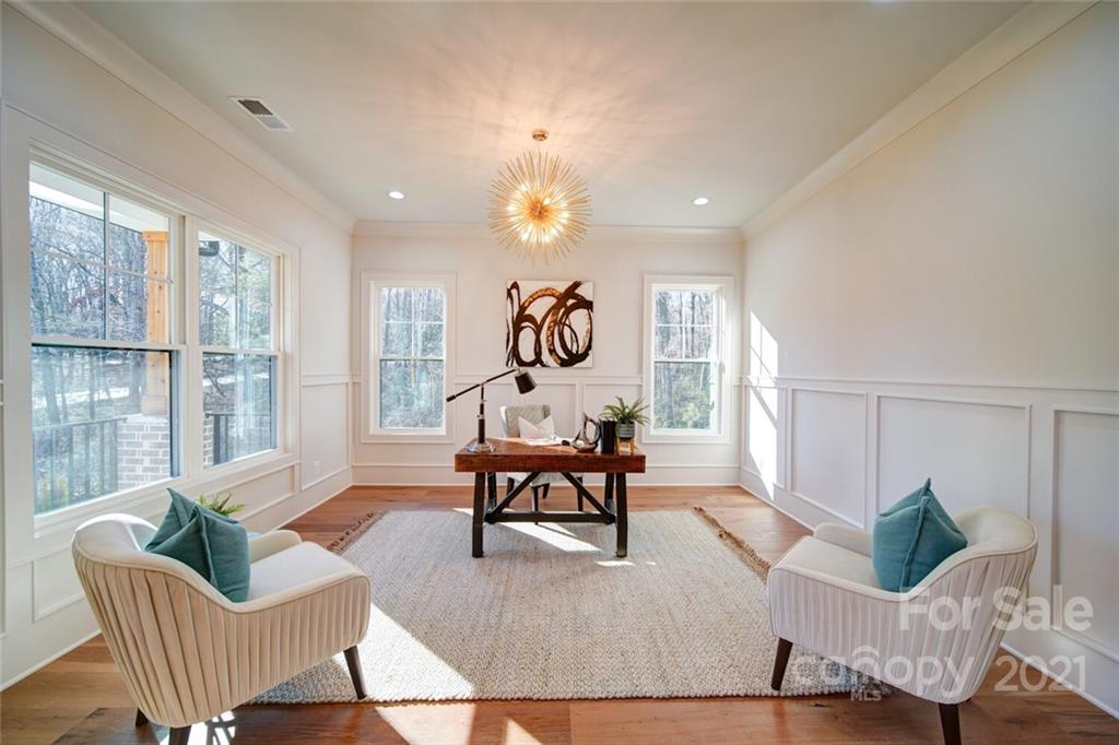 3017 McLendon Road Matthews, NC 28104 - Photo 10 of 47 a living room with couches a table and chairs with wooden floor