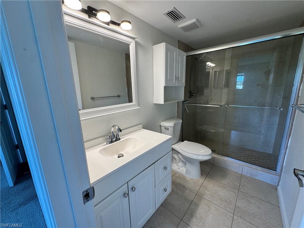 5667 Rattlesnake Hamm Road North, Unit B301 Naples, FL 34113 - Photo 11 of 17 a bathroom with a toilet sink and shower