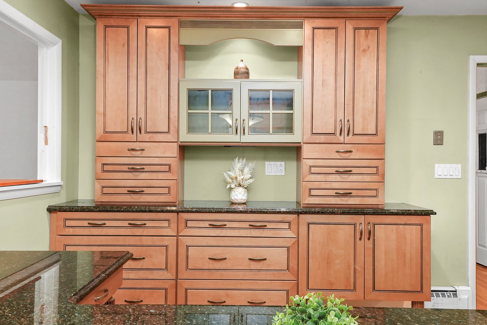 1406 Lincoln Road McHenry, IL 60051 - Photo 11 of 39 a kitchen with white cabinets and a wooden floor