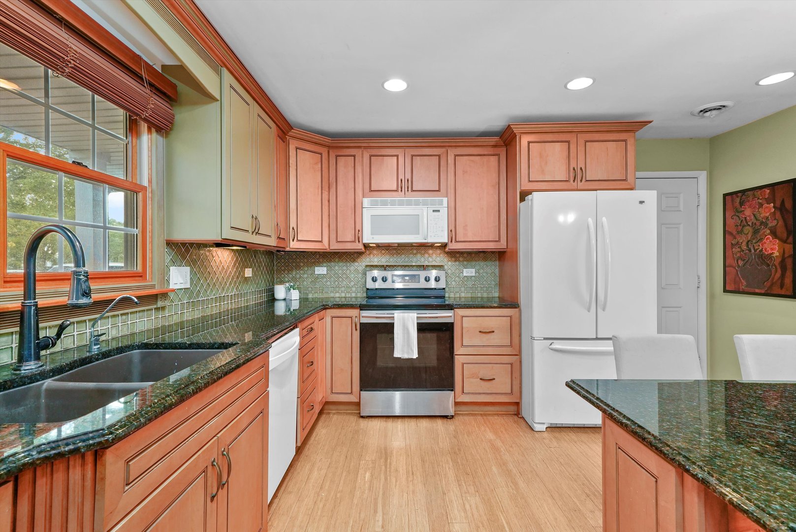 1406 Lincoln Road McHenry, IL 60051 - Photo 13 of 39 a kitchen with stainless steel appliances granite countertop a stove a sink and a refrigerator with wooden cabinets
