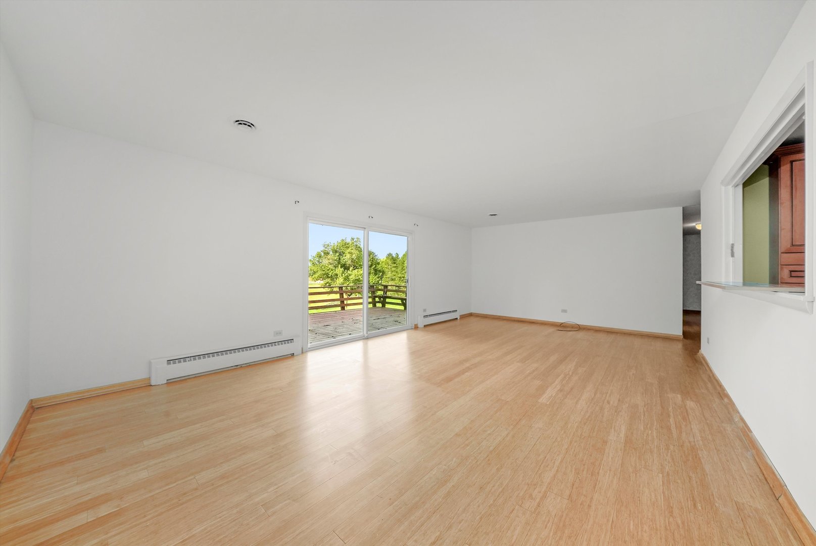 1406 Lincoln Road McHenry, IL 60051 - Photo 17 of 39 a view of an empty room with wooden floor and a window