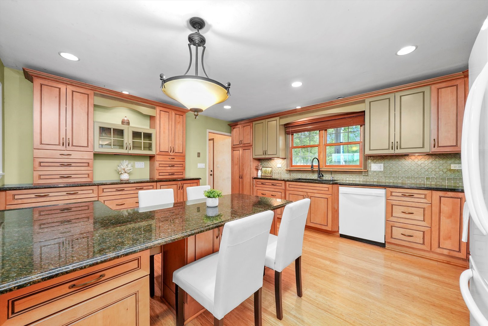 1406 Lincoln Road McHenry, IL 60051 - Photo 9 of 39 a kitchen with stainless steel appliances granite countertop wooden cabinets a dining table and chairs with wooden floor