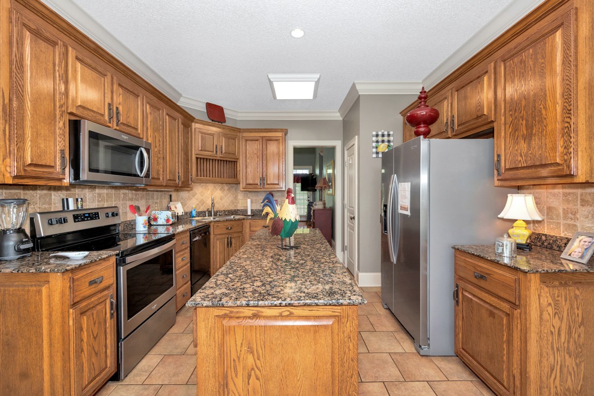 21 Meeting House Road Ardmore, TN 38449 - Photo 17 of 62 a kitchen with stainless steel appliances granite countertop a refrigerator a stove top oven a sink and dishwasher