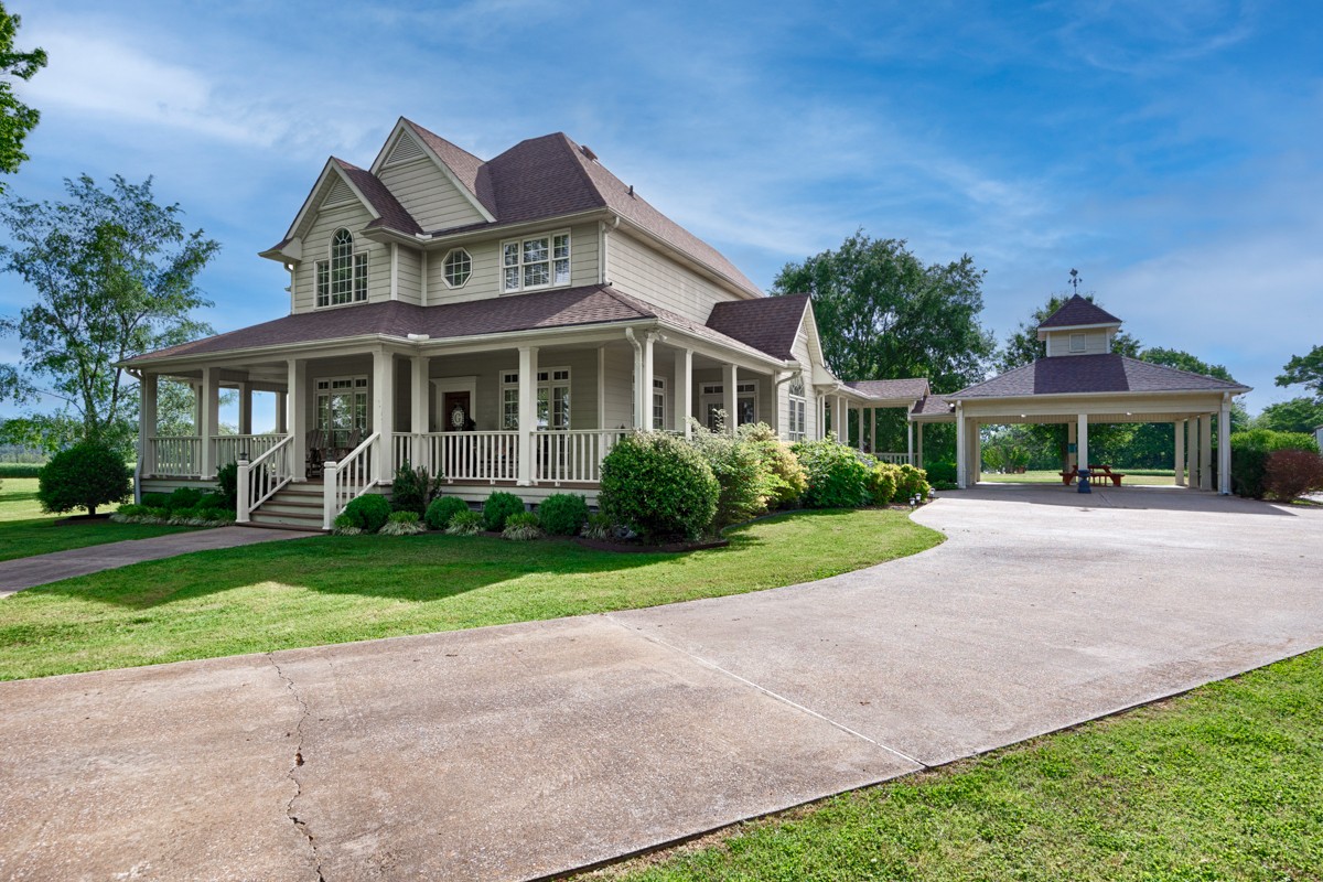 21 Meeting House Road Ardmore, TN 38449 - Photo 34 of 62 a front view of a house with a yard and potted plants
