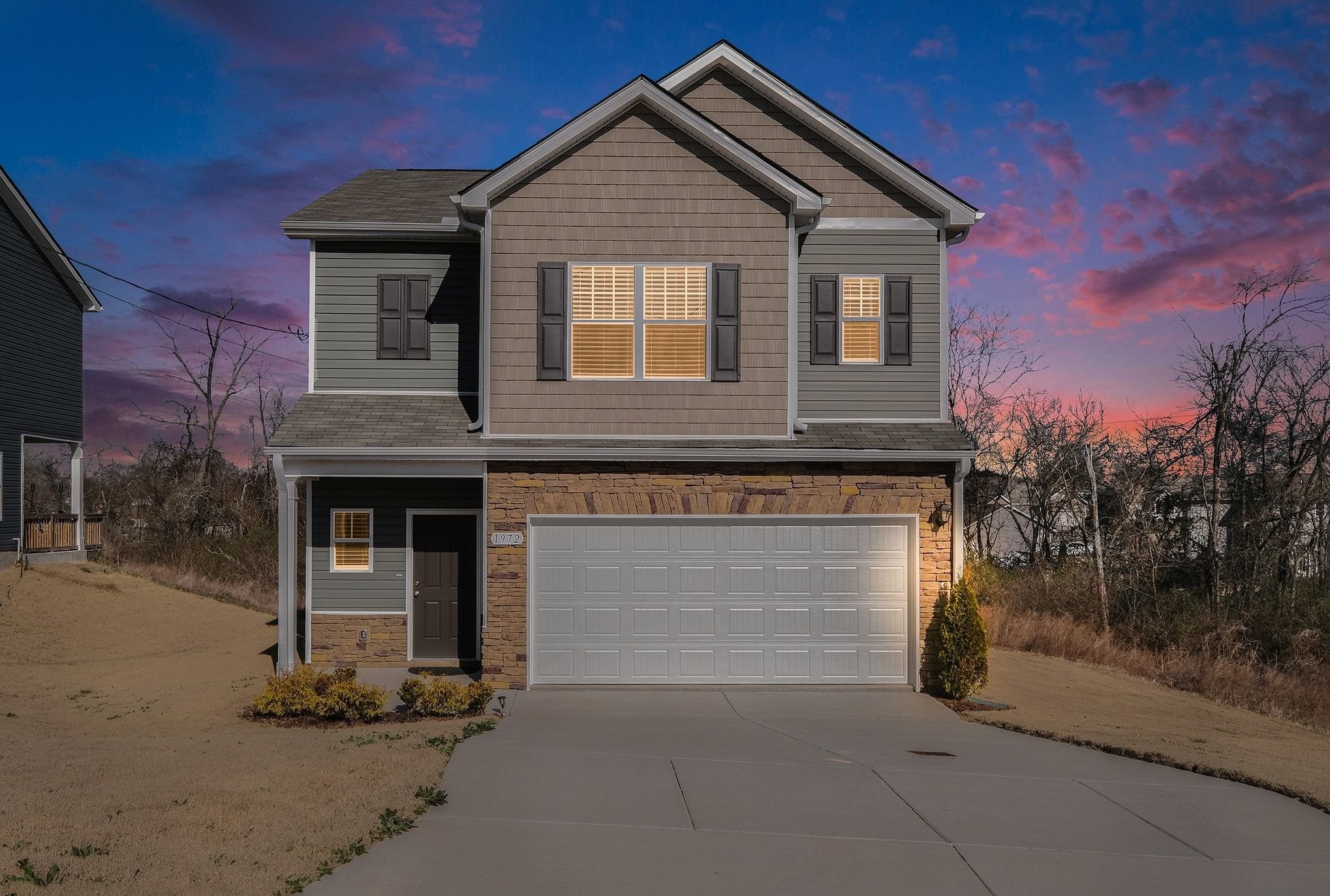 a front view of a house with garage
