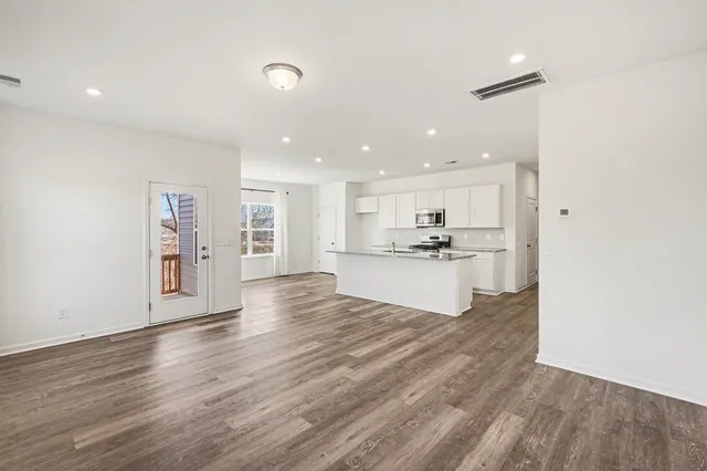 a view of kitchen with cabinets and wooden floor