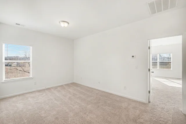 a view of an empty room with a window