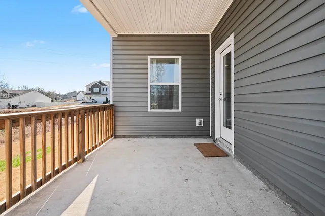 a brick house with a yard and plants