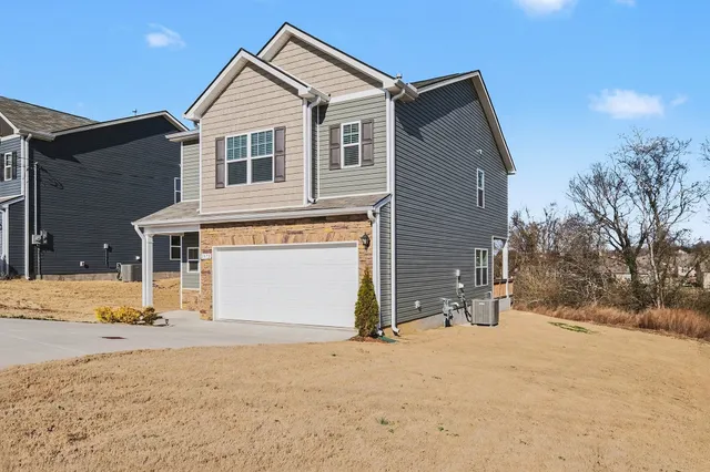 a view of house with snow on the road