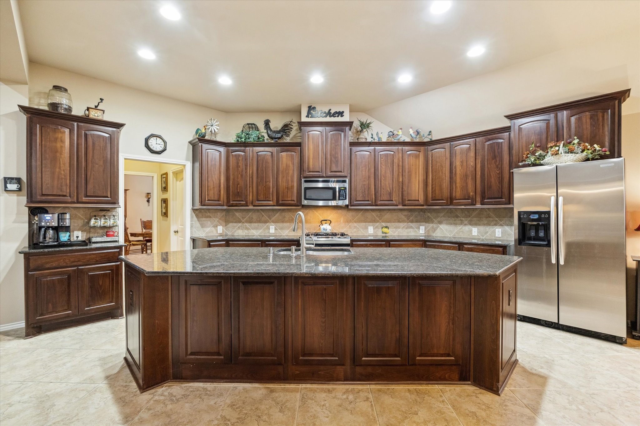 5231 Stoneridge Court Rosenberg, TX 77471 - Photo 11 of 31 The kitchen is the heart of the home, featuring rich cabinetry, granite countertops, stainless appliances, generous counter space, and a large center island with seating.
