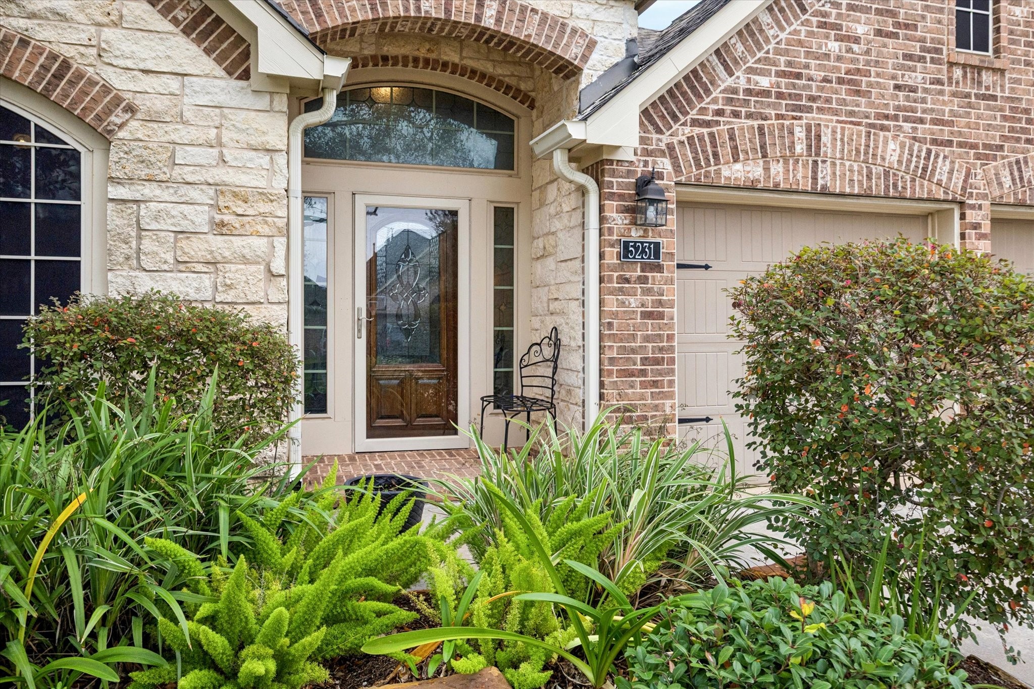 5231 Stoneridge Court Rosenberg, TX 77471 - Photo 2 of 31 An inviting covered entry with a decorative glass front door sets a refined tone, offering a warm welcome and beautiful curb appeal.