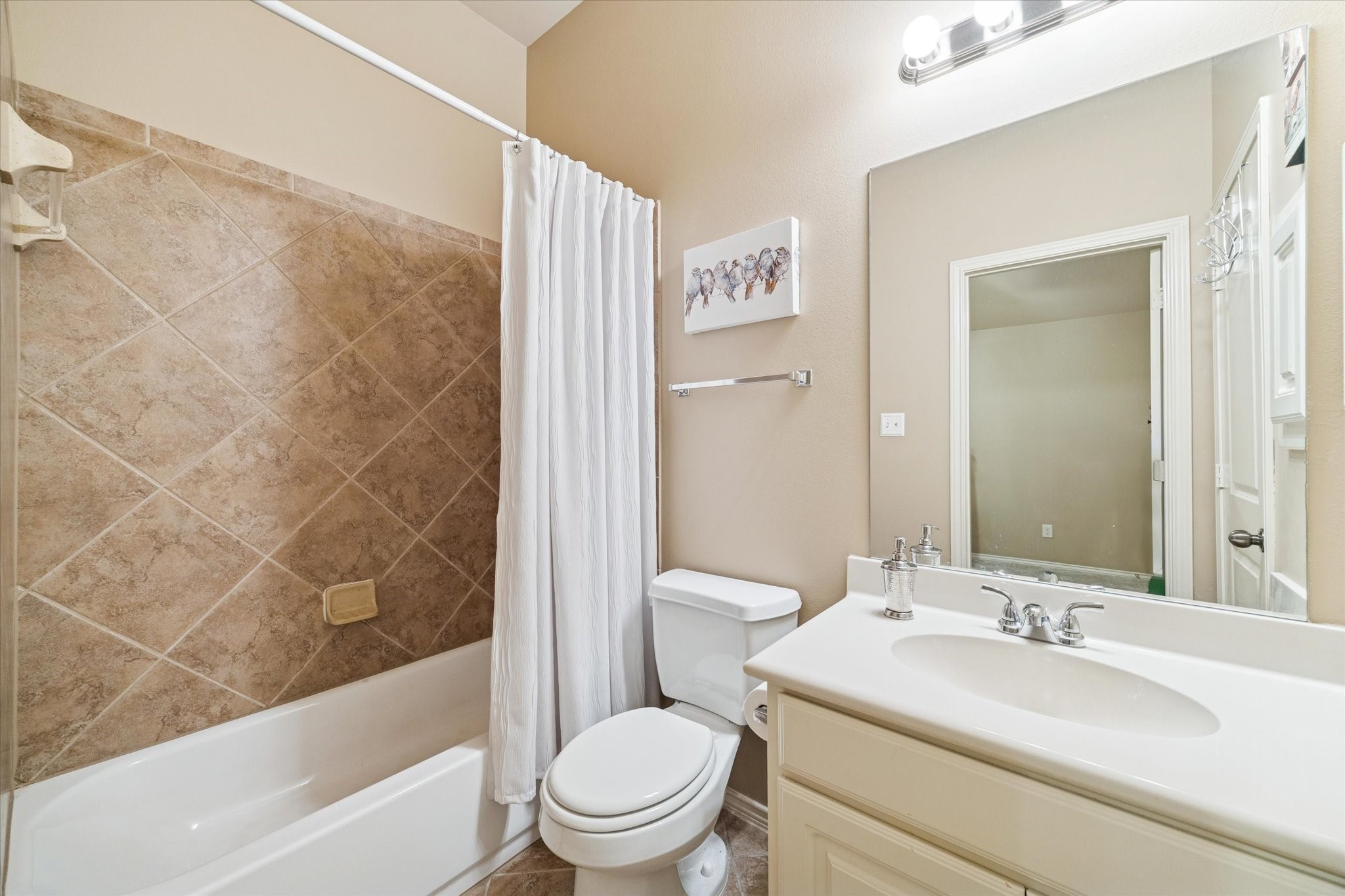 5231 Stoneridge Court Rosenberg, TX 77471 - Photo 24 of 31 Private ensuite bathroom featuring a tub/shower combination, updated vanity, and neutral finishes for a clean, timeless look.