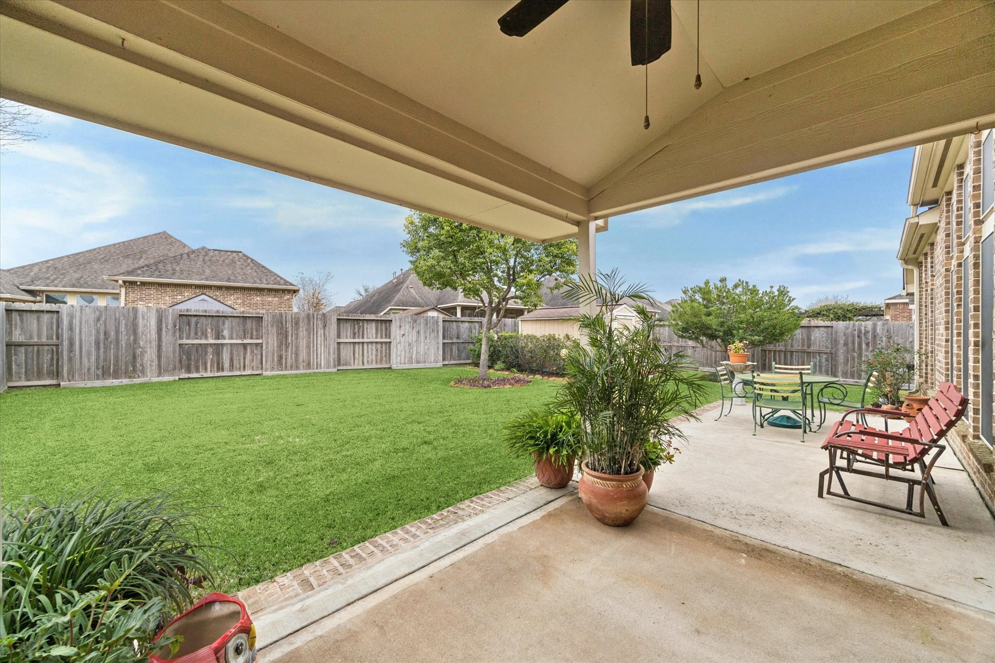 5231 Stoneridge Court Rosenberg, TX 77471 - Photo 27 of 31 Enjoy outdoor living year-round on the covered patio, overlooking a well-maintained backyard with room to relax, play, or entertain.