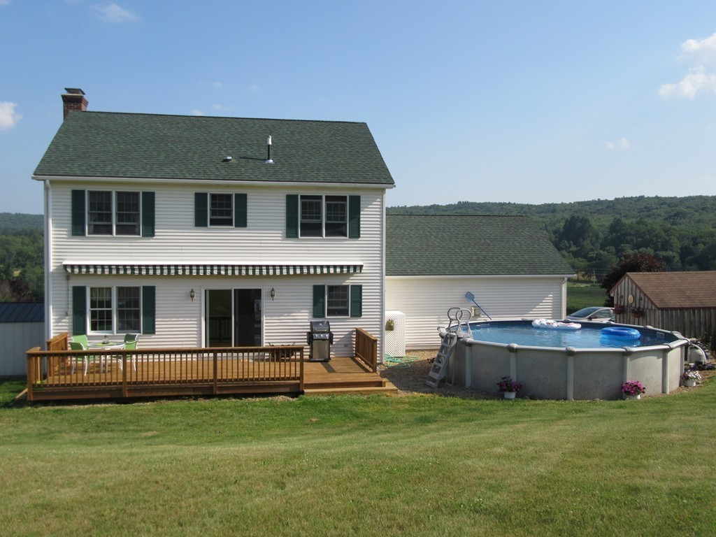 156 Reed Street Warren, MA 01083 - Photo 22 of 30 a front view of a house with a garden and porch