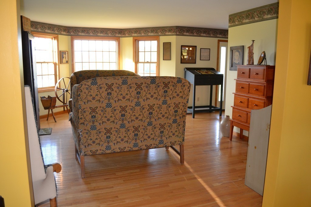 156 Reed Street Warren, MA 01083 - Photo 9 of 30 a living room with couches bookshelf and a large window