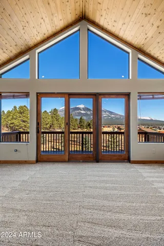 a living room with furniture and a ceiling fan