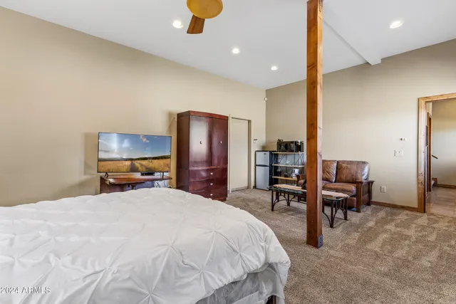 a living room with furniture pool table and windows