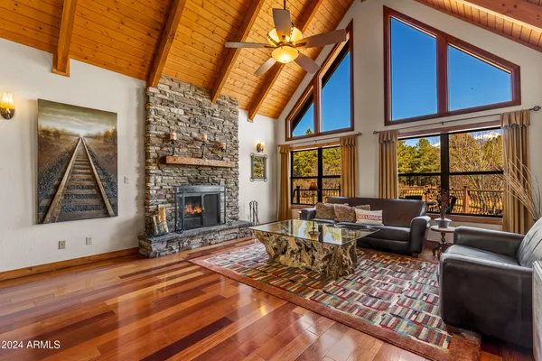a living room with furniture a rug and a large window